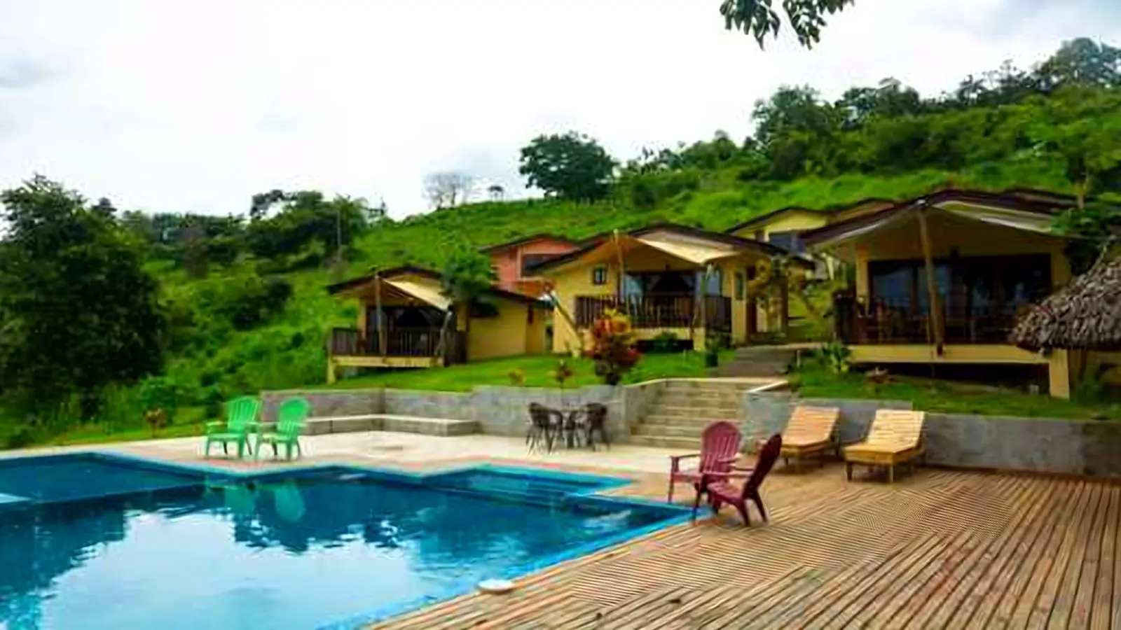 Lodge pool and cabins surrounded by greenery